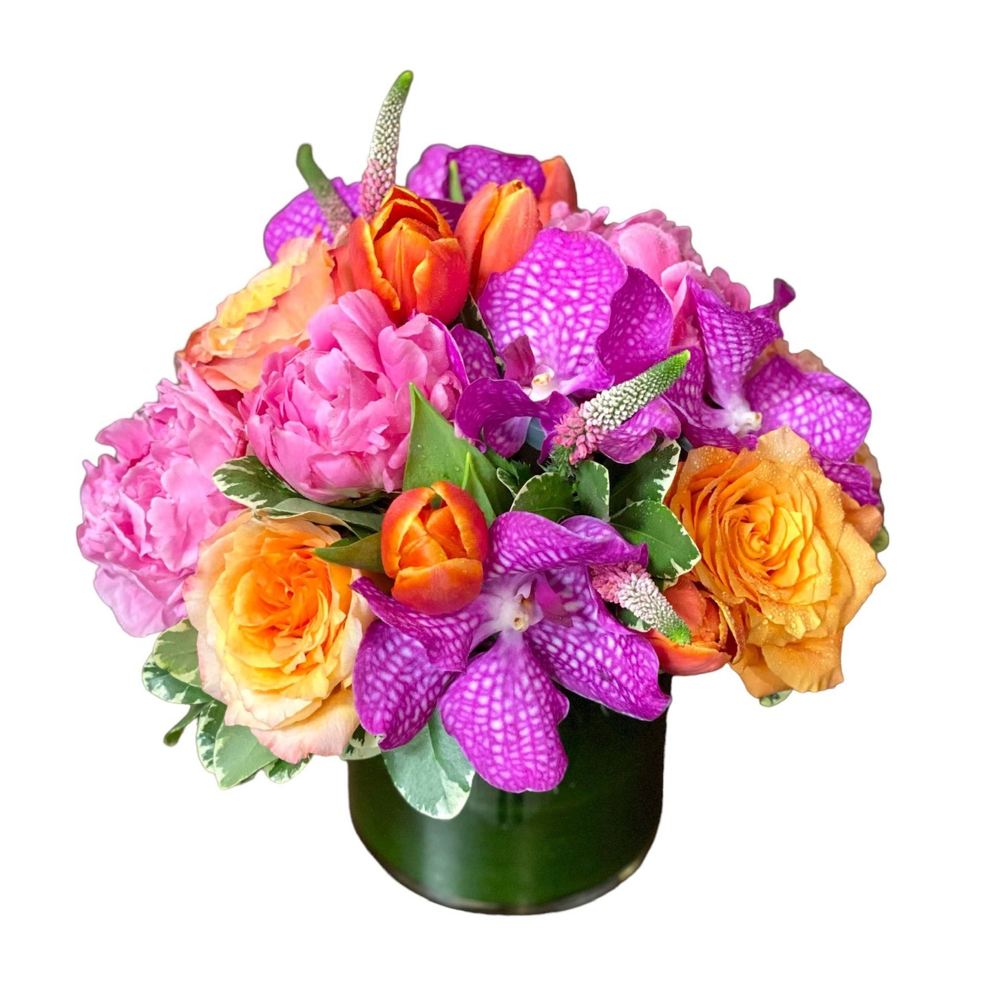 Low and lush flower arrangement called Spring Sunset featuring pink, orange, and green flowers like peonies, tulips, and vanda orchids